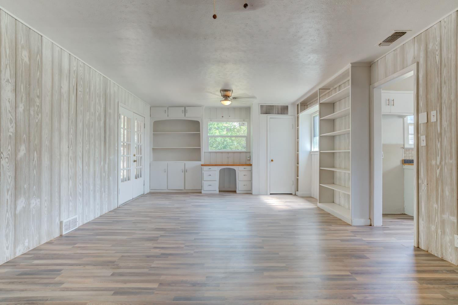 3411 41st Street Lubbock, TX 79413 - Photo 14 of 29 a view of a big room with wooden floor and windows
