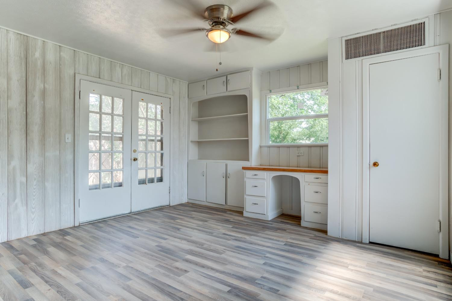 3411 41st Street Lubbock, TX 79413 - Photo 16 of 29 a view of empty room with wooden floor and fan