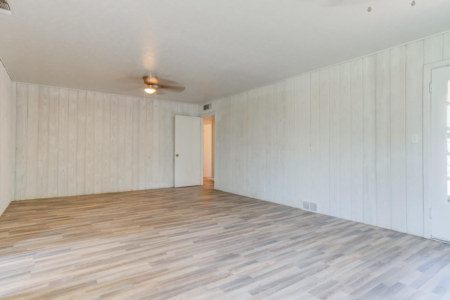 3411 41st Street Lubbock, TX 79413 - Photo 17 of 29 a view of an empty room with wooden floor