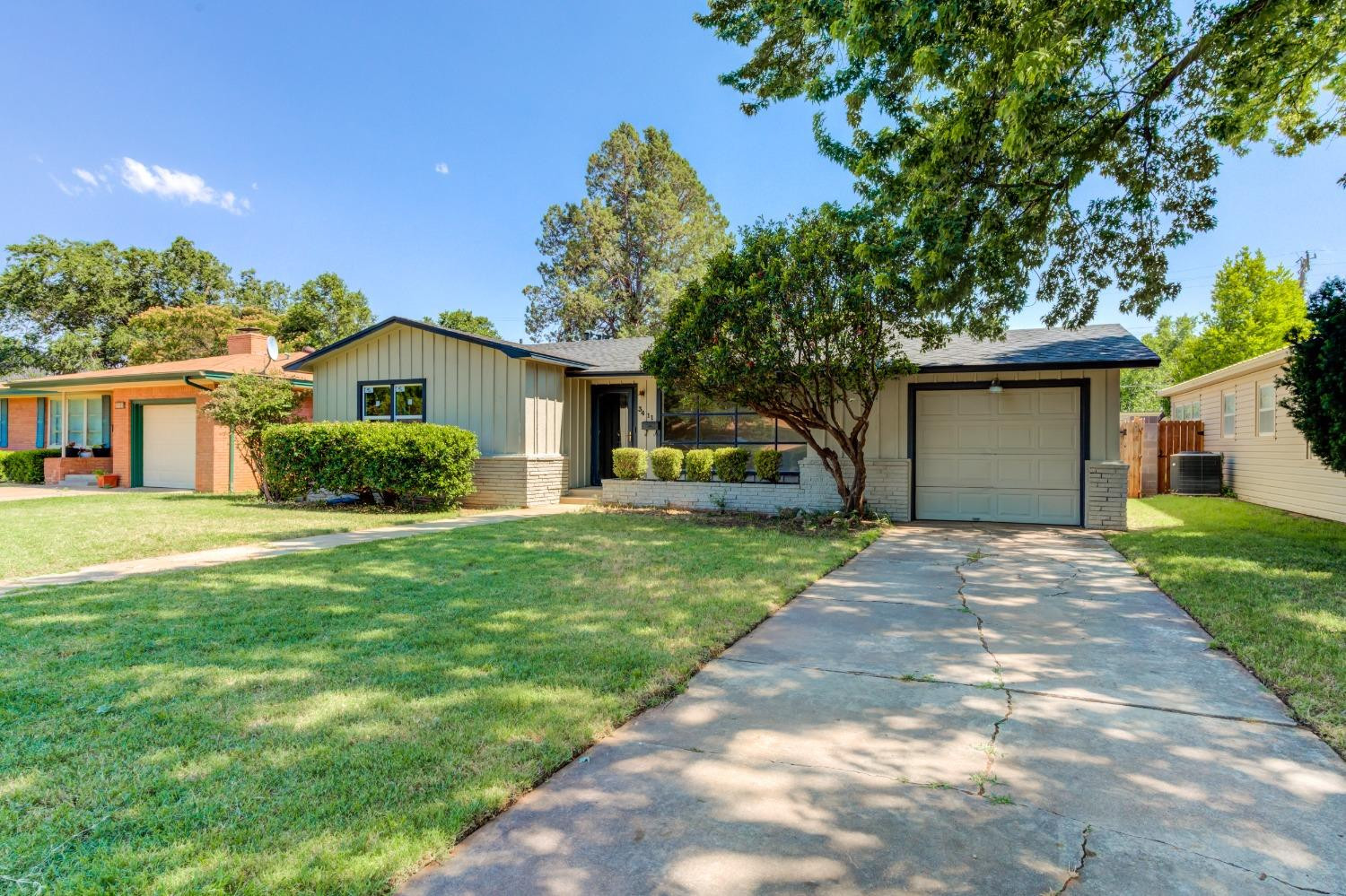 3411 41st Street Lubbock, TX 79413 - Photo 2 of 29 a front view of a house with a garden