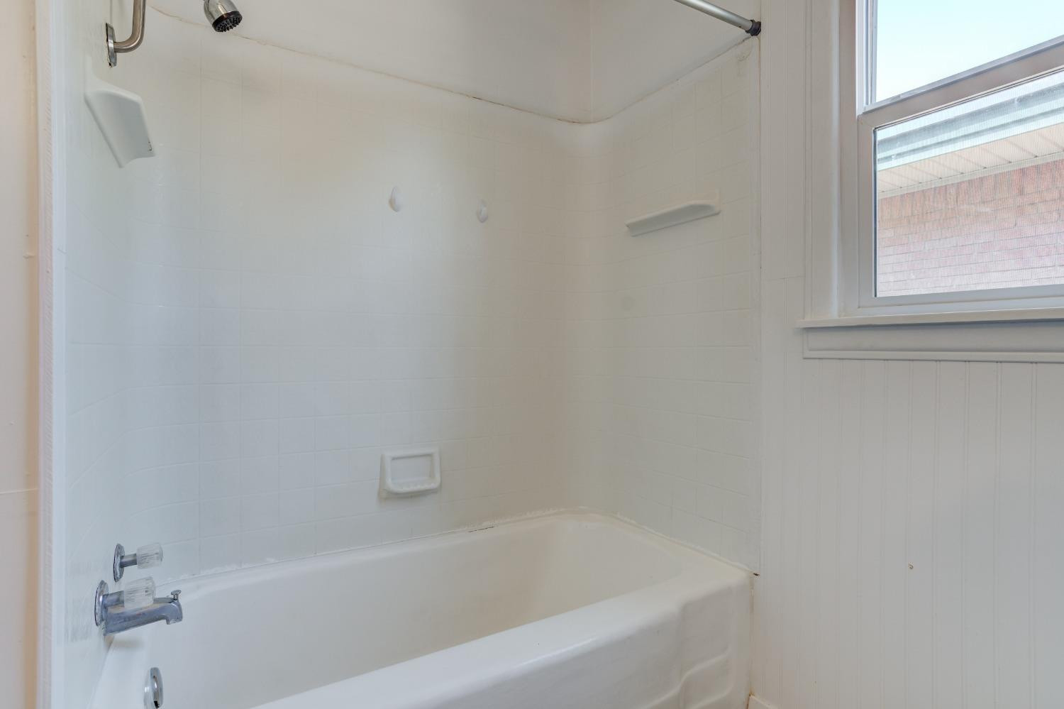 3411 41st Street Lubbock, TX 79413 - Photo 23 of 29 a bathroom with a bathtub