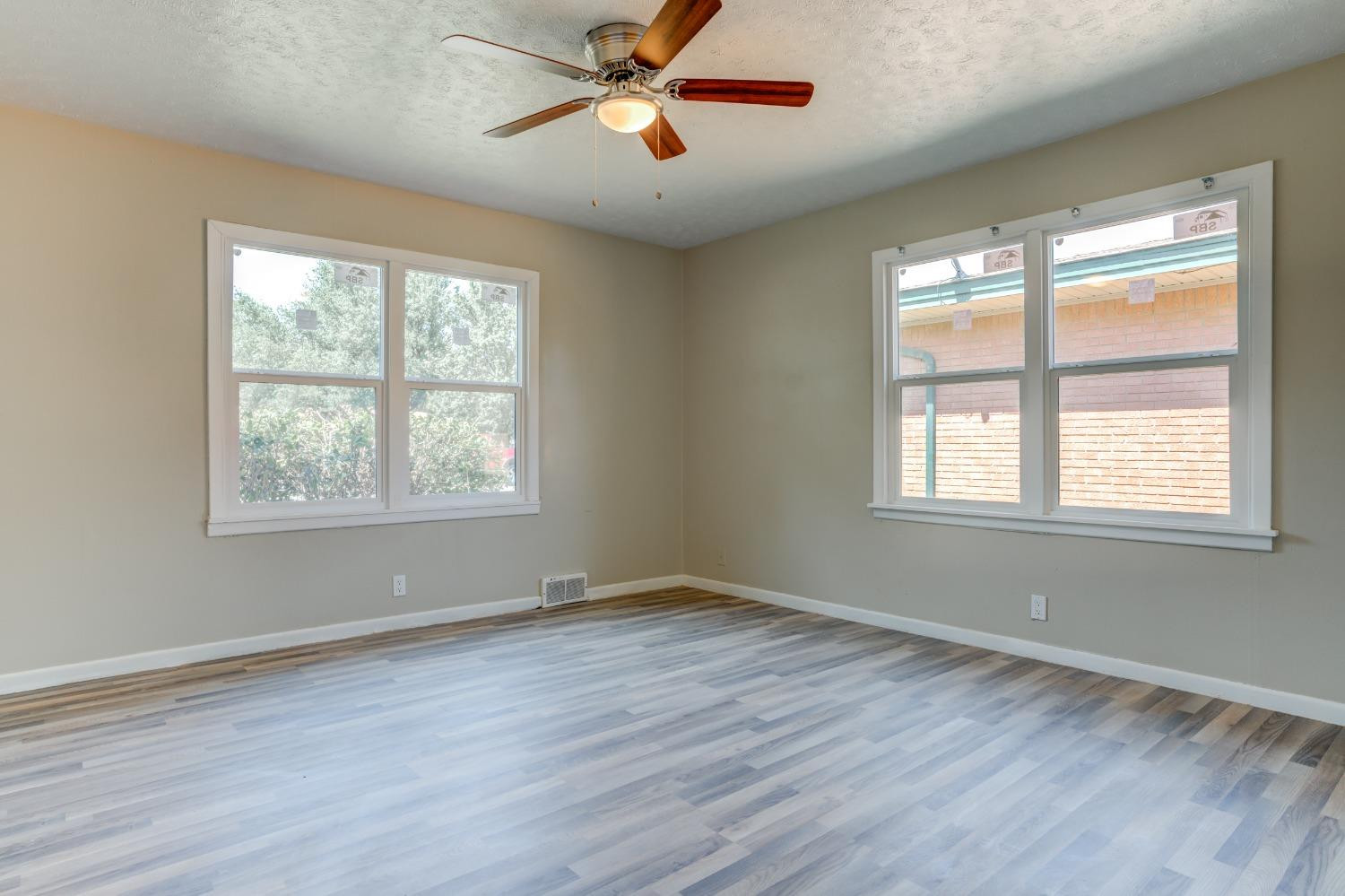 3411 41st Street Lubbock, TX 79413 - Photo 24 of 29 a view of empty room with wooden floor and fan