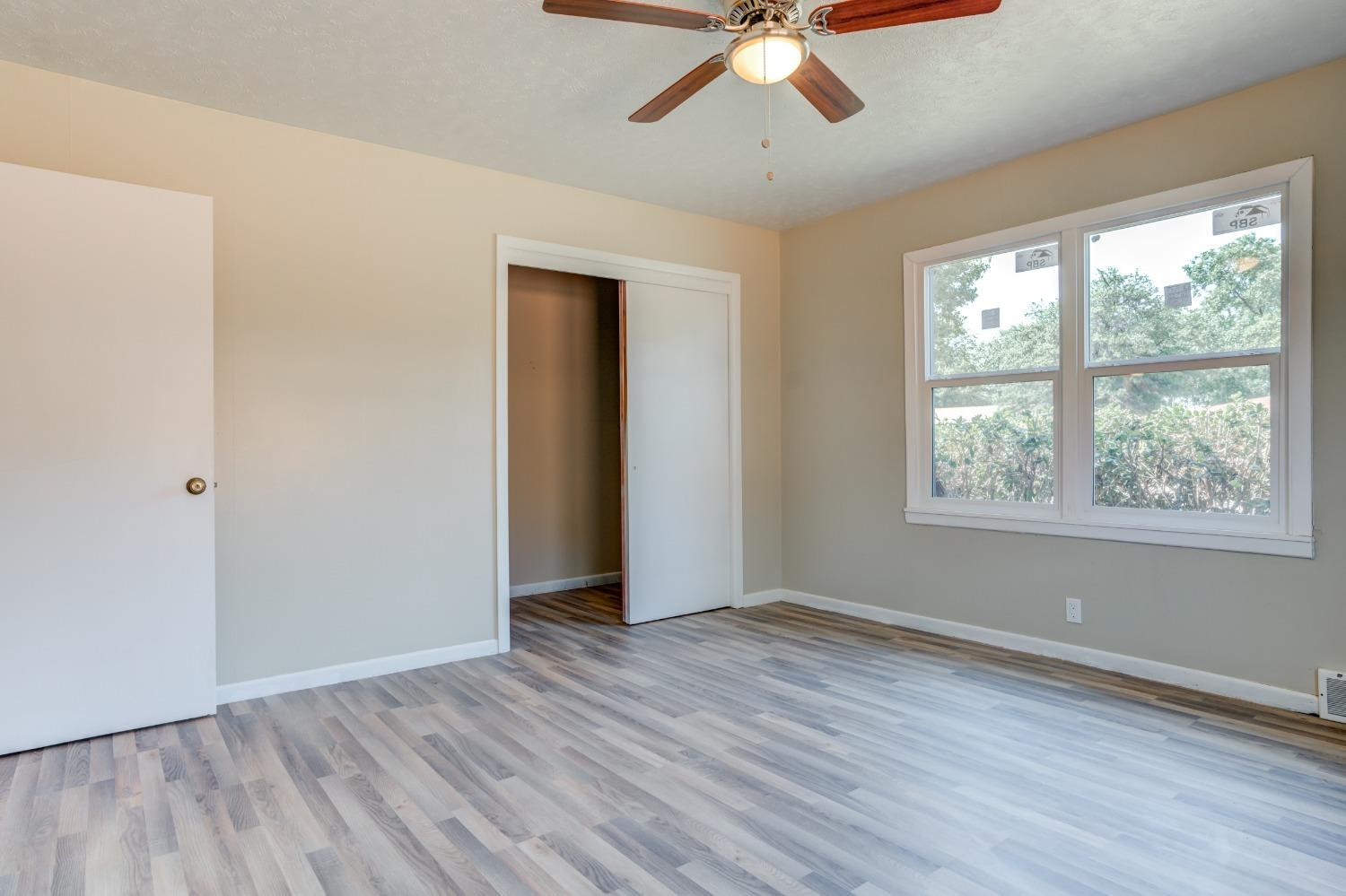 3411 41st Street Lubbock, TX 79413 - Photo 25 of 29 a view of an empty room with wooden floor and a window
