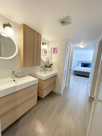 a bathroom with a sink double vanity and a mirror