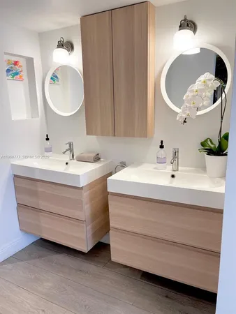 a view of a bedroom with wooden floor