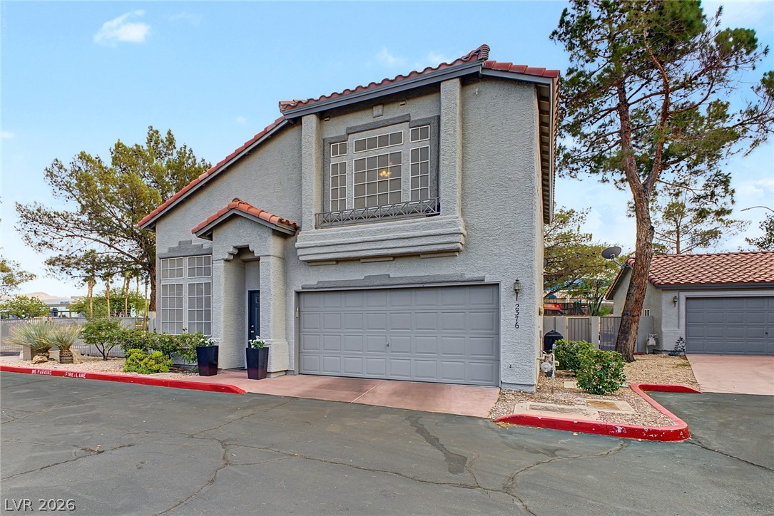 Spanish tile accents and classic stucco walls define this multi-level exterior architecture.