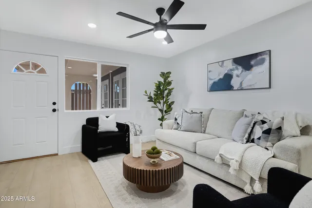 a living room with furniture a window and a chandelier