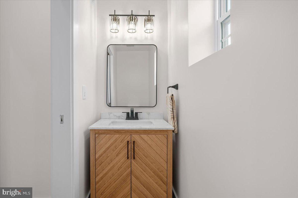 800 Elder Street Northwest Washington, DC 20012 - Photo 16 of 56 a bathroom with a granite countertop sink and mirror