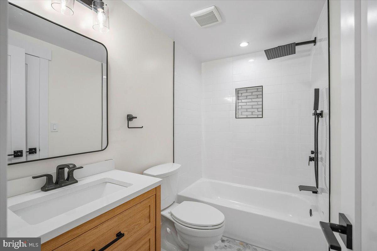 800 Elder Street Northwest Washington, DC 20012 - Photo 35 of 56 a bathroom with a granite countertop sink toilet and shower