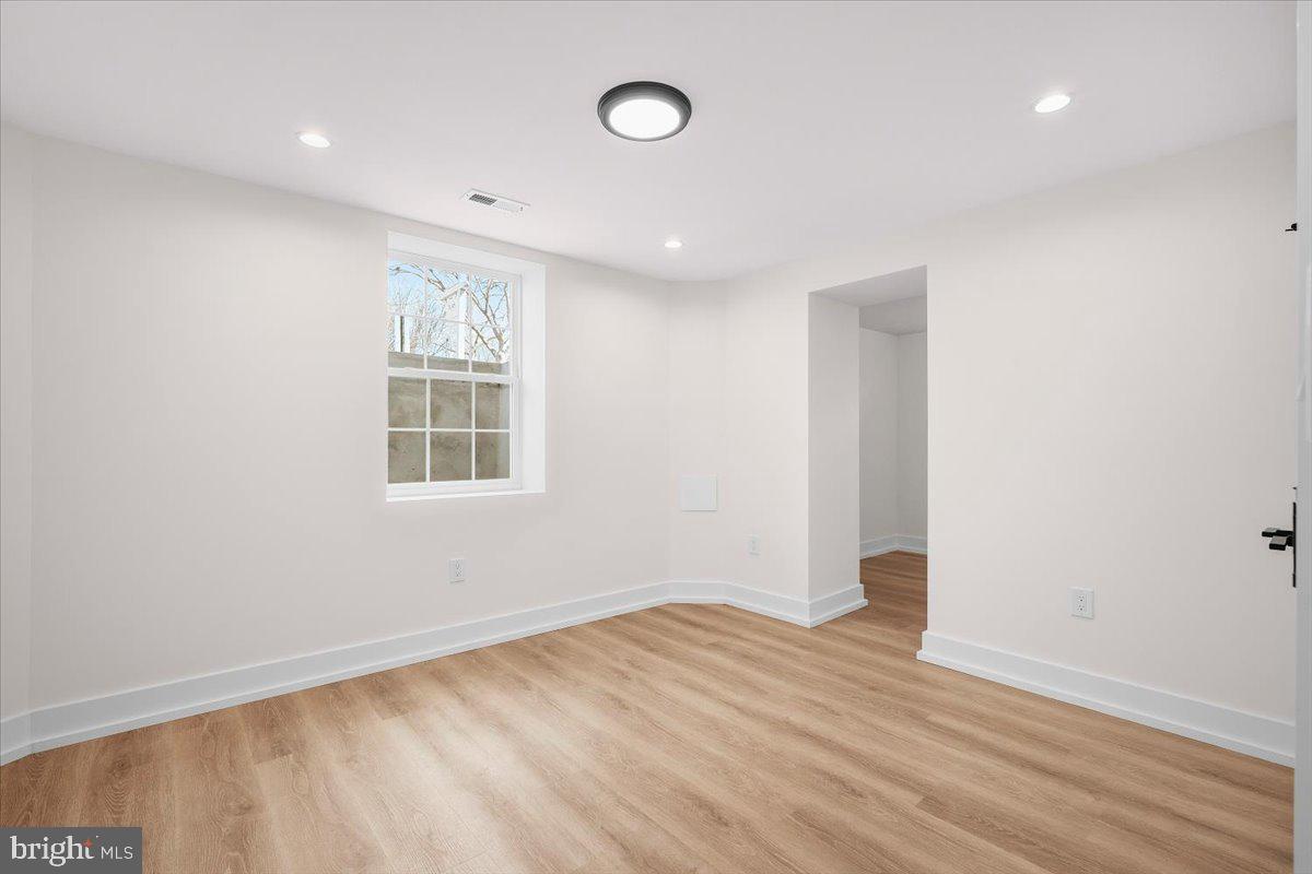 800 Elder Street Northwest Washington, DC 20012 - Photo 37 of 56 an empty room with wooden floor and windows