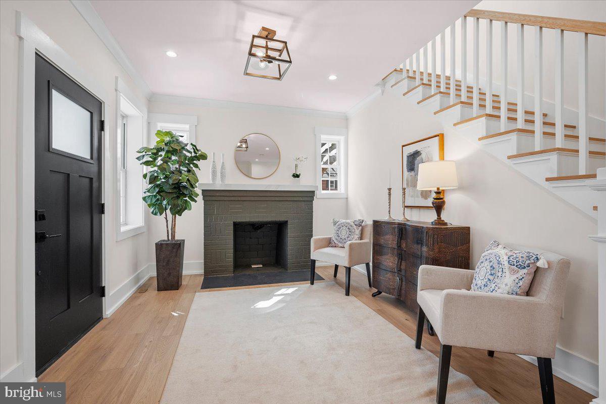 800 Elder Street Northwest Washington, DC 20012 - Photo 4 of 56 a living room with furniture a fireplace and a large mirror