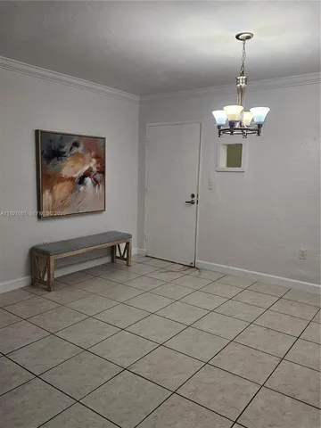 a view of a room with wooden floor and furniture