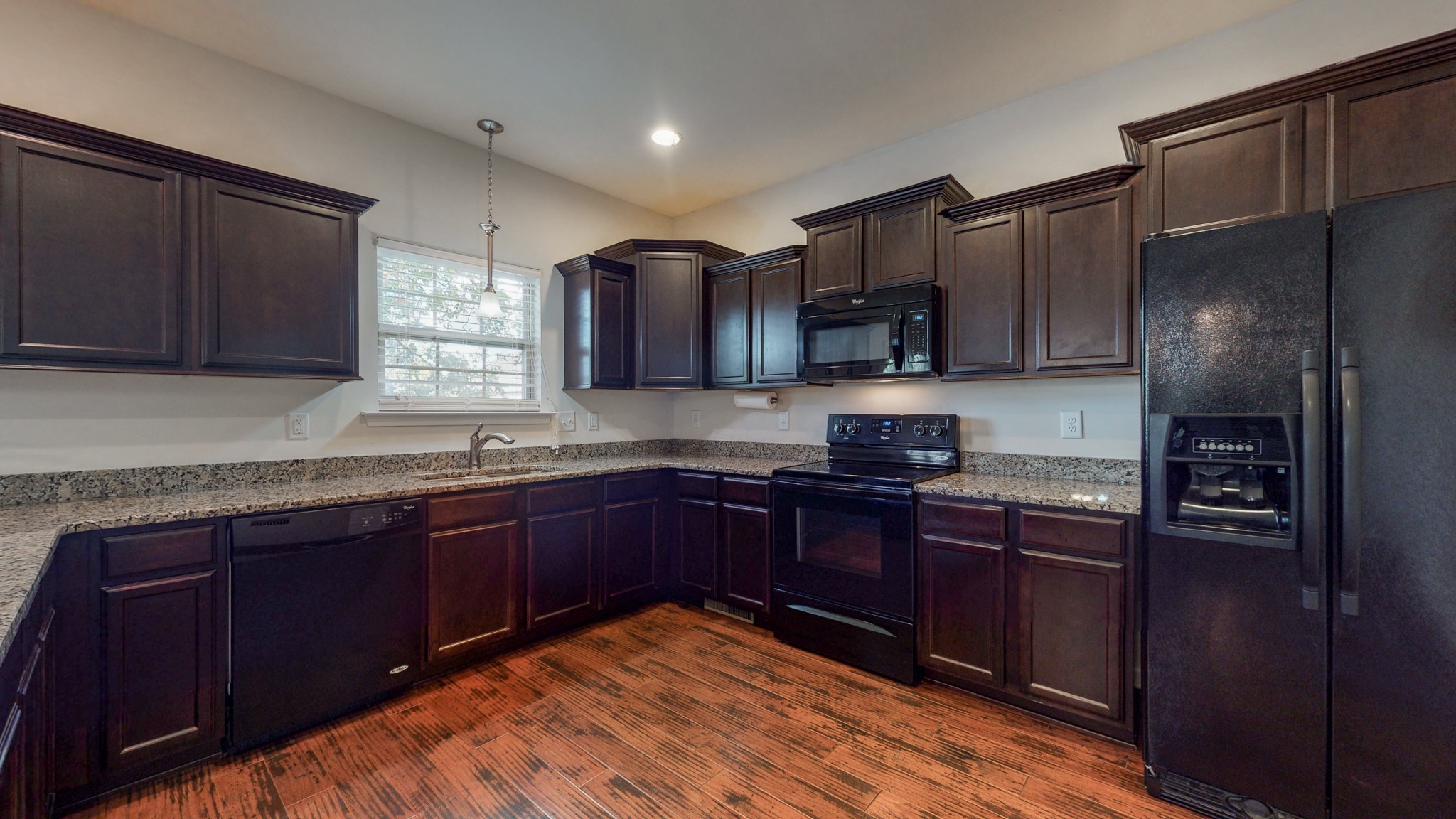 1004 Kyle Road Spring Hill, TN 37174 - Photo 14 of 40 a kitchen with stainless steel appliances granite countertop wooden cabinets a refrigerator and a sink