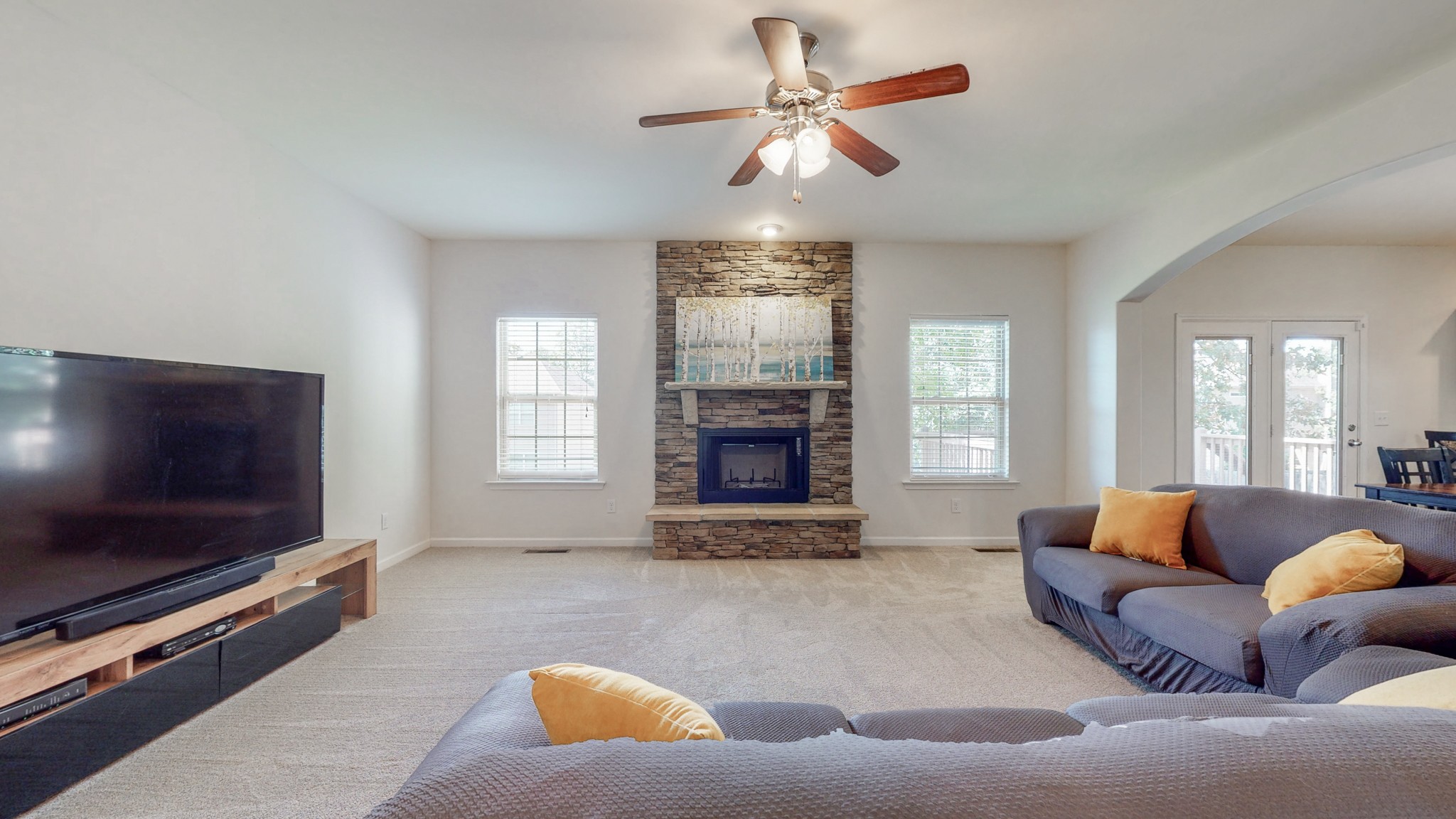 1004 Kyle Road Spring Hill, TN 37174 - Photo 10 of 40 a living room with furniture flat screen tv and a fireplace