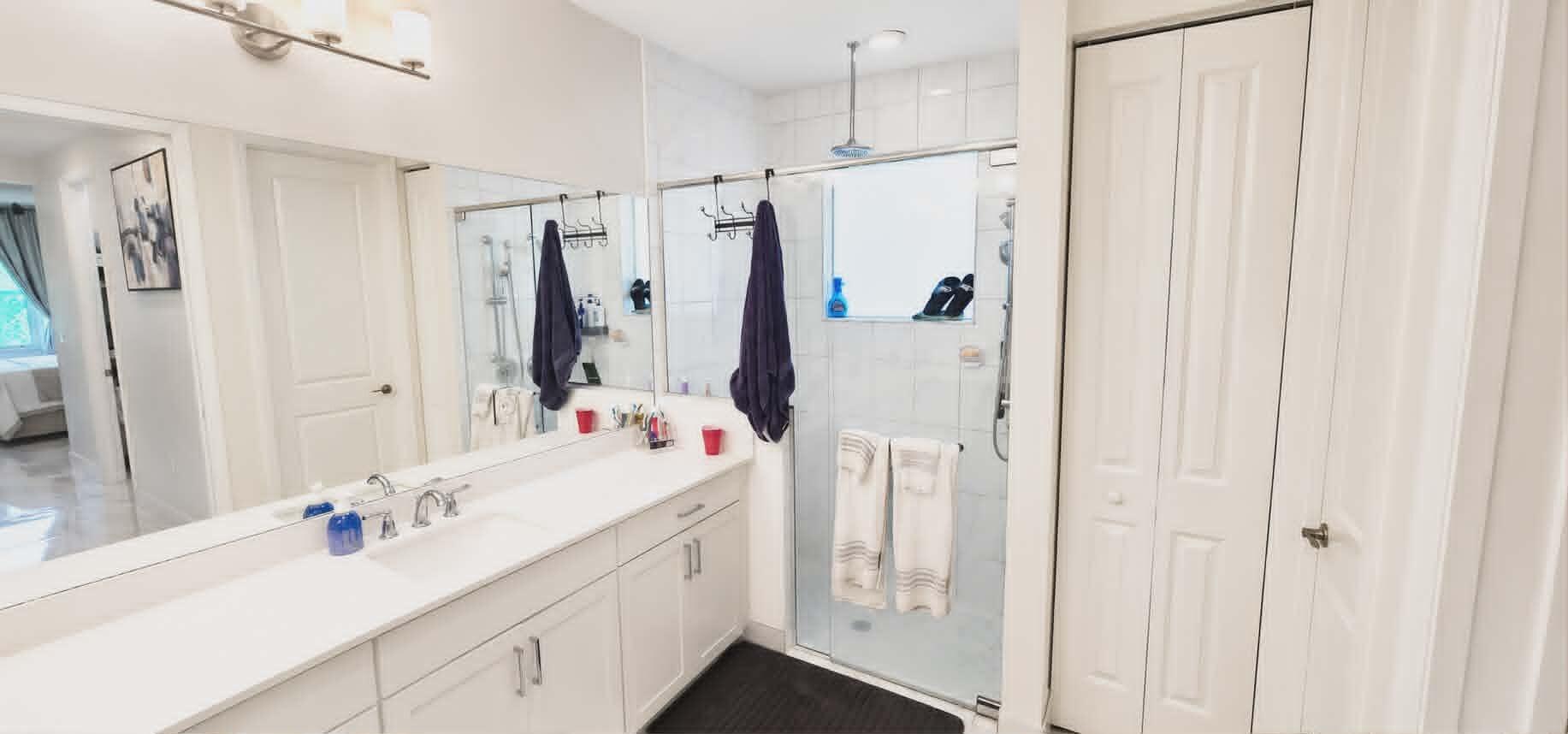19179 Rolling Acrs Road Loxahatchee, FL 33470 - Photo 28 of 38 a bathroom with a double vanity sink a mirror a shower and a bathtub