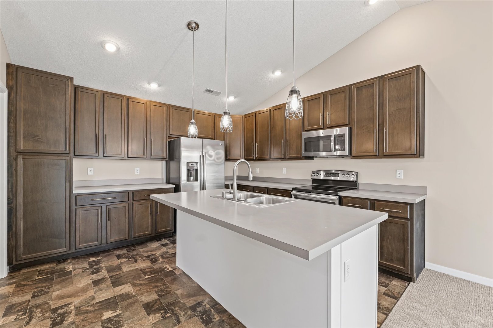 3109 Stanley Lane Champaign, IL 61822 - Photo 15 of 39 a kitchen with kitchen island granite countertop a stove sink microwave and cabinets