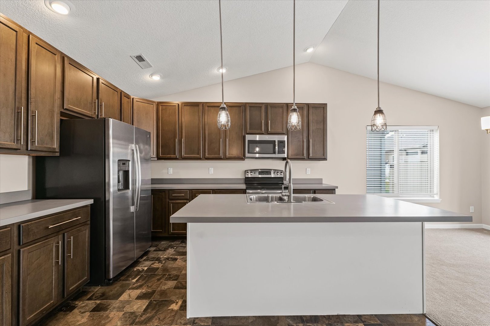 3109 Stanley Lane Champaign, IL 61822 - Photo 16 of 39 a kitchen with stainless steel appliances granite countertop a sink a stove a refrigerator a center island and cabinets