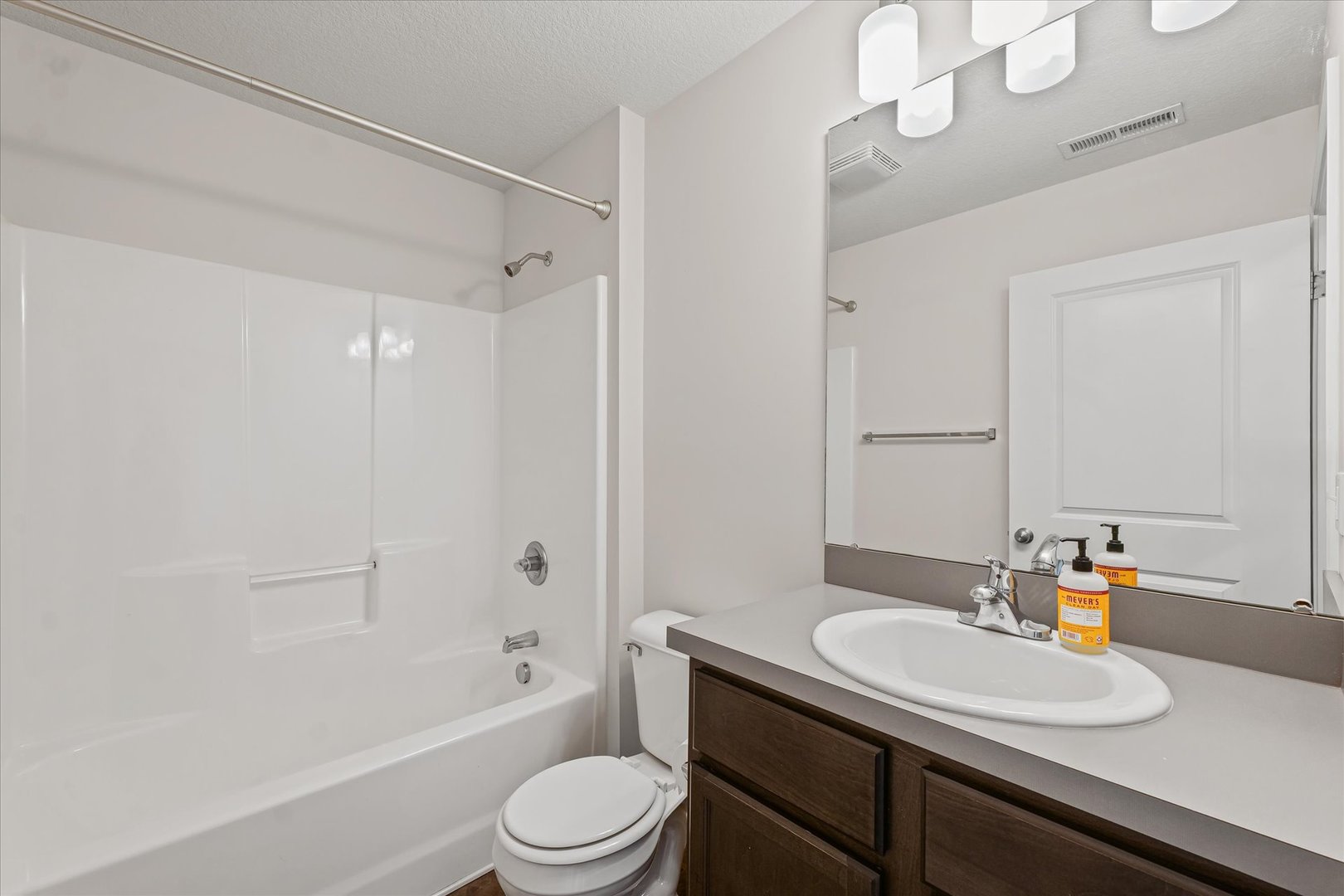 3109 Stanley Lane Champaign, IL 61822 - Photo 31 of 39 a bathroom with a granite countertop sink a toilet a mirror and shower