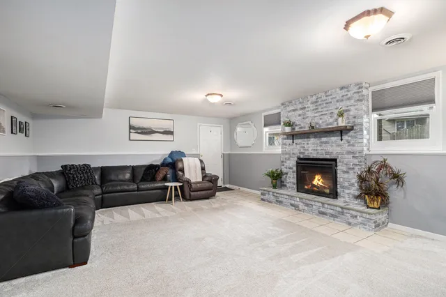 a living room with furniture and a fireplace