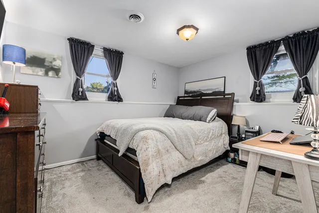 a bedroom with a bed a desk and chair