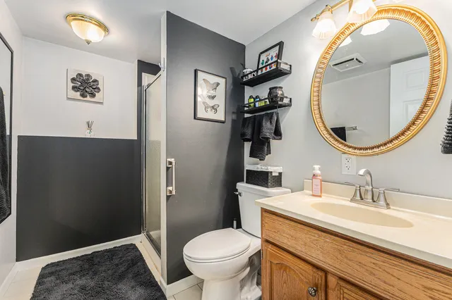 a bathroom with a toilet a sink and mirror