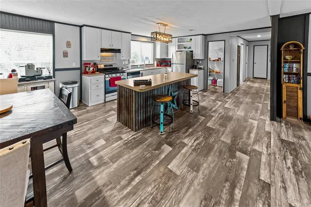 a living room with furniture a flat screen tv and a table