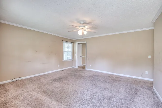 a view of an empty room with a ceiling fan