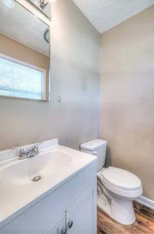 a bathroom with a sink a toilet and mirror