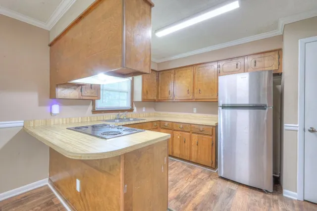 a kitchen with a sink appliances and cabinets