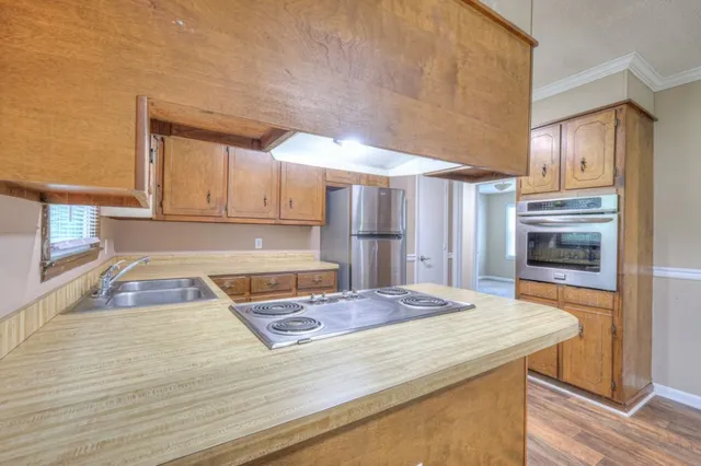 a kitchen with granite countertop a stove and cabinets