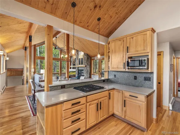 a kitchen with stainless steel appliances granite countertop a sink and wooden cabinets