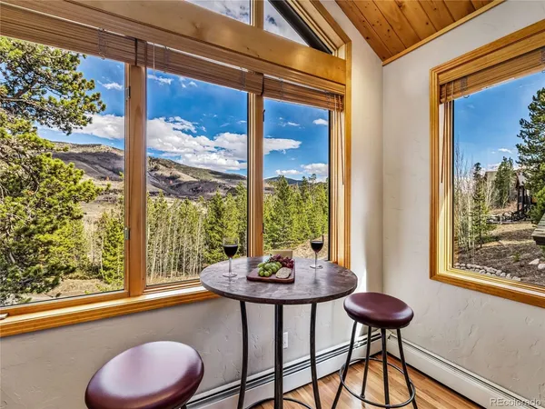 a view of a room with a large window and table