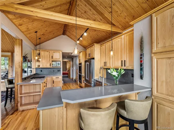 a dining table with chairs and wooden floor