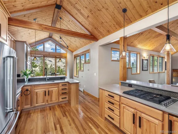 a kitchen with sink cabinets and wooden floor