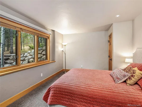 a bedroom with a large bed and a large window