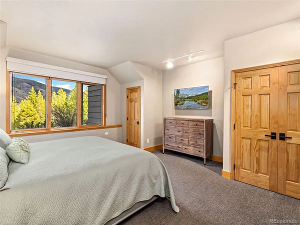 a bed room with a bed and a window