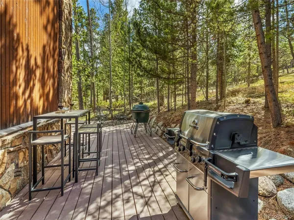 a view of a patio with table and chairs with wooden floor and fence