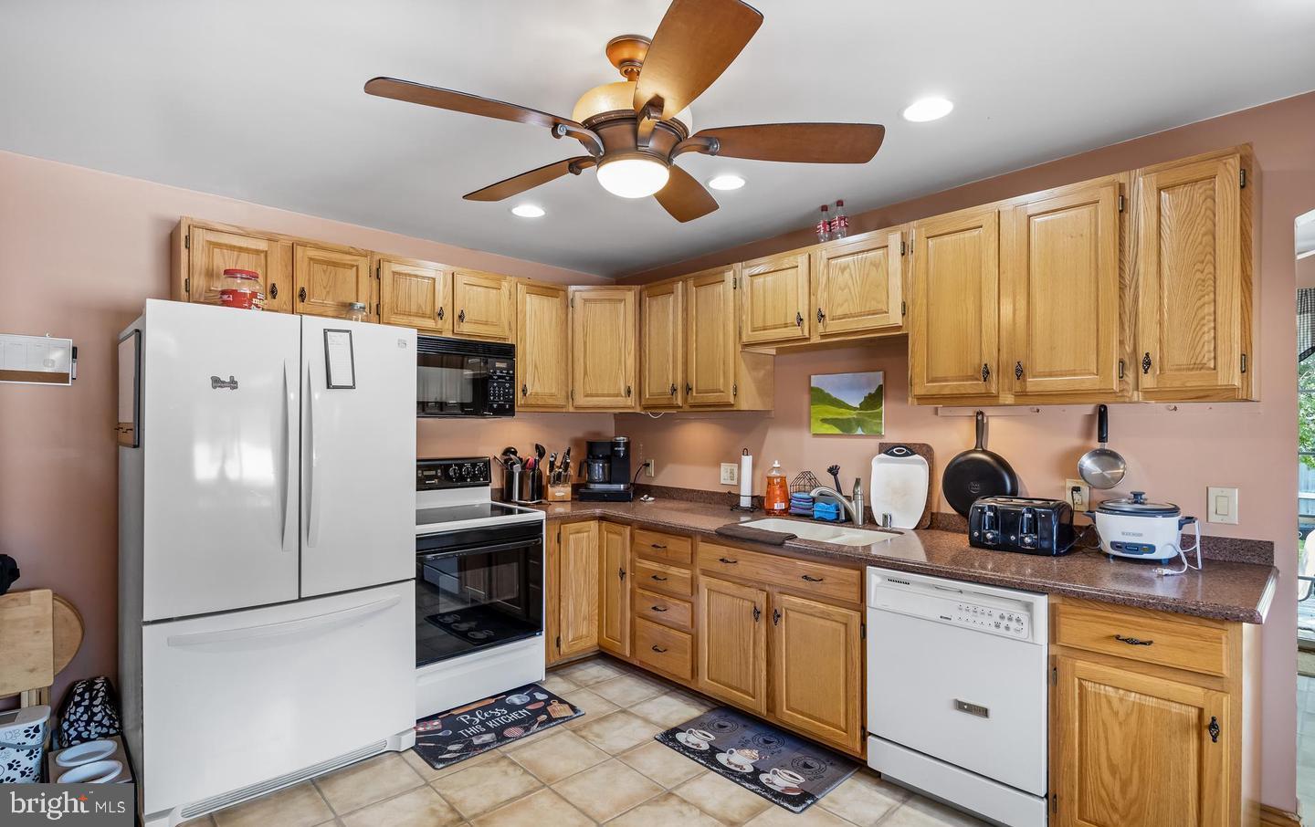 316 Lippincott Avenue Riverside, NJ 08075 - Photo 9 of 17 a kitchen with stainless steel appliances granite countertop a refrigerator a stove a sink dishwasher and white cabinets with wooden floor