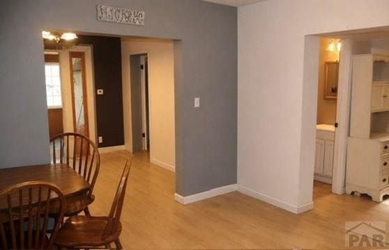 11229 County Rd JJ 5 Manzanola, CO 81058 - Photo 9 of 32 a view of a hallway to a room with furniture and windows