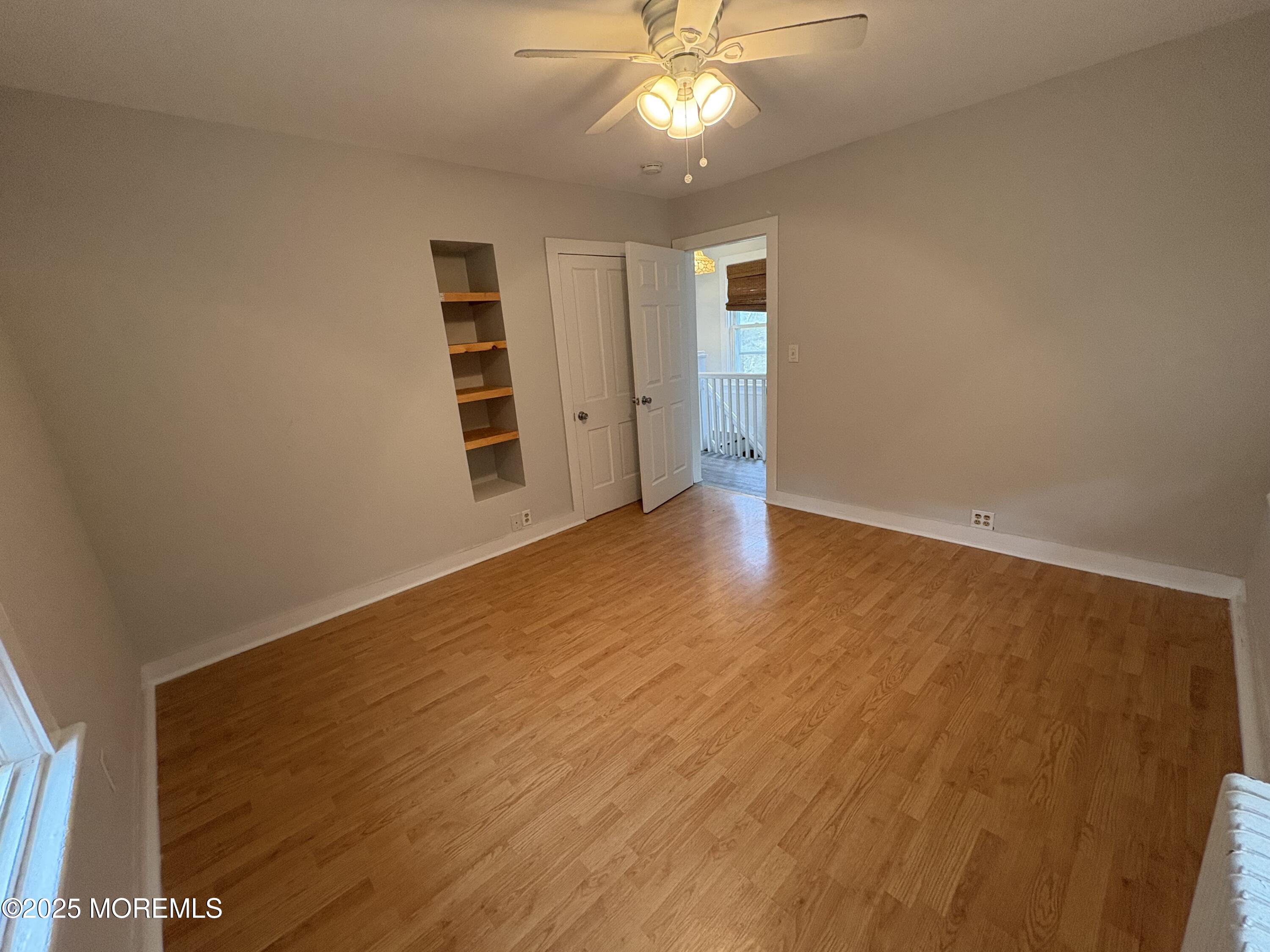 479 Line Road Matawan, NJ 07747 - Photo 14 of 17 an empty room with a windows and chandelier fan