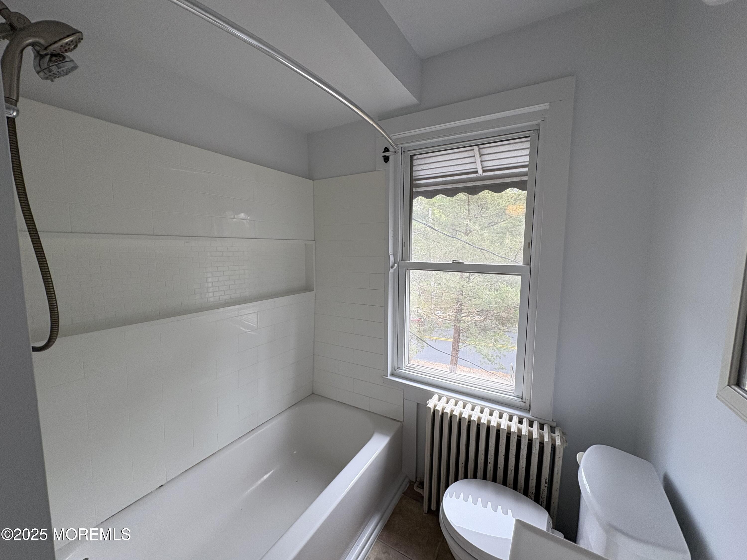 479 Line Road Matawan, NJ 07747 - Photo 15 of 17 a bathroom with a tub toilet and window
