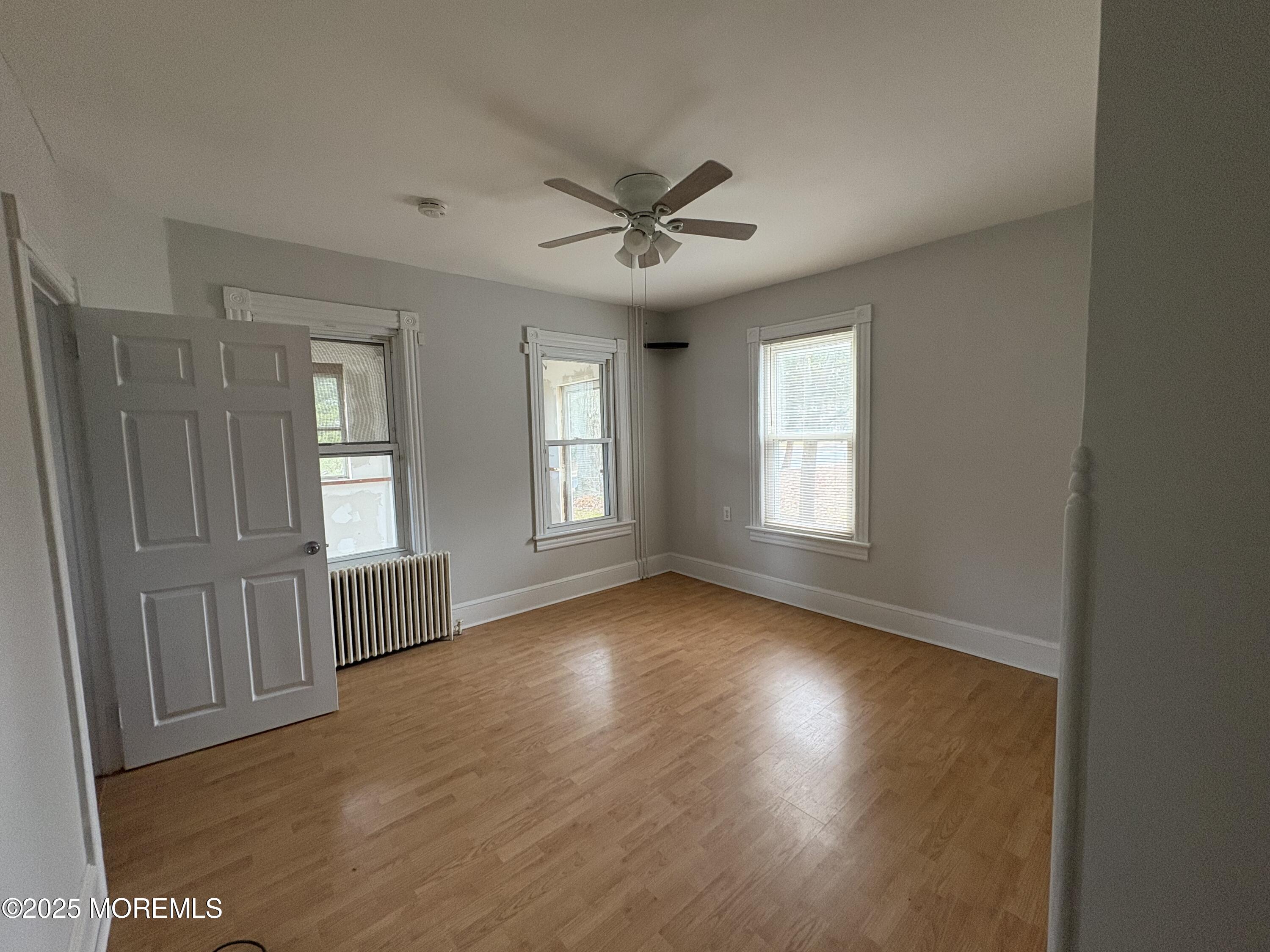 479 Line Road Matawan, NJ 07747 - Photo 7 of 17 wooden floor in an empty room with a window