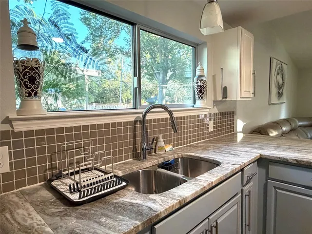a kitchen with a sink and a window