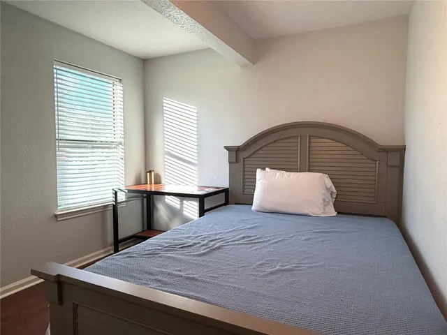 a bedroom with a bed and a window