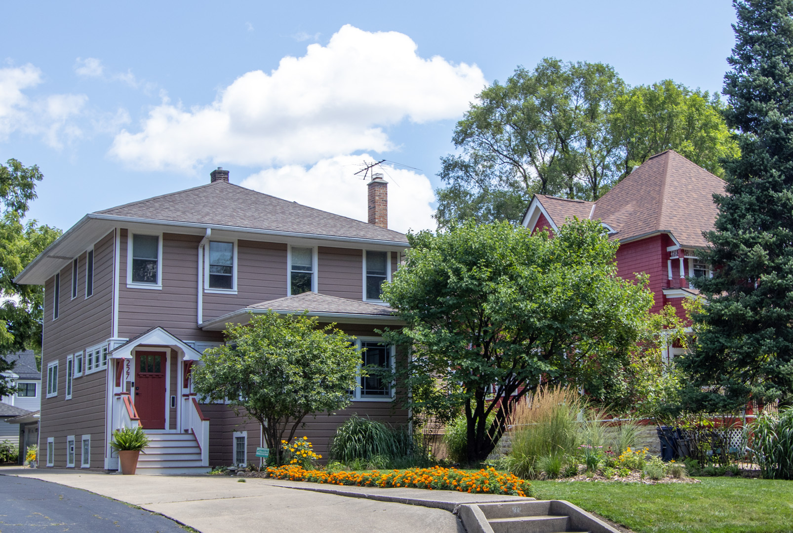 a view of a house with a yard and potted plants
