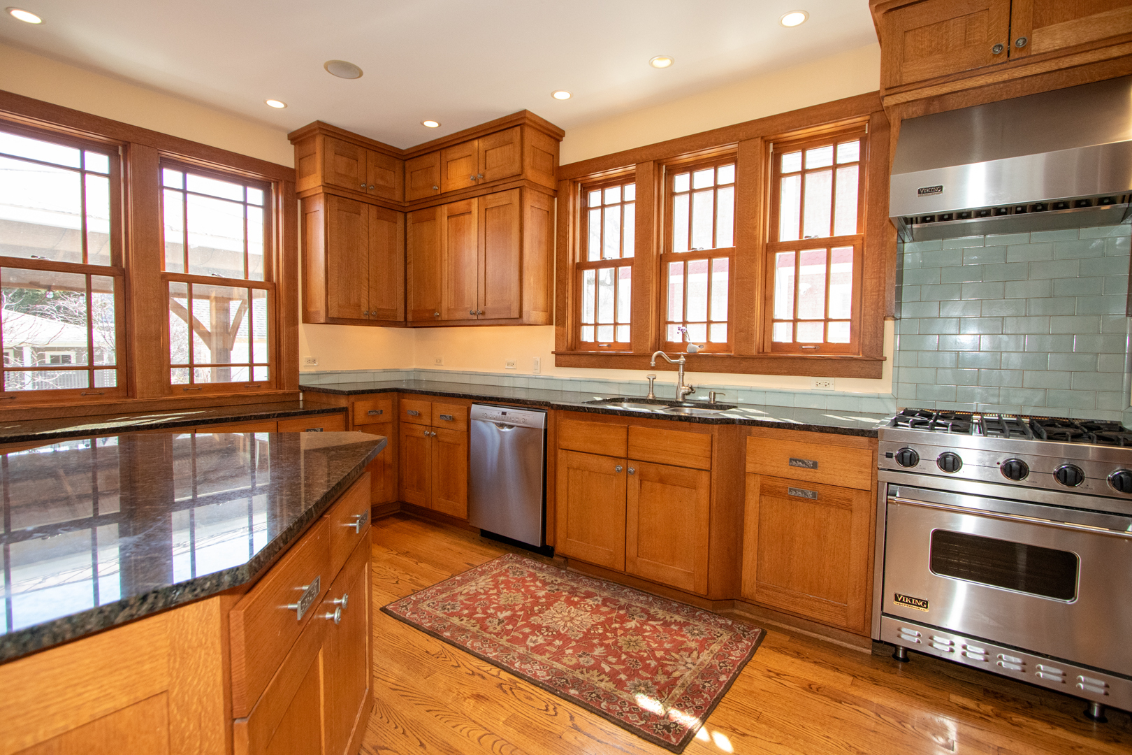 227 Thatcher Avenue River Forest, IL 60305 - Photo 14 of 42 a kitchen with stainless steel appliances granite countertop a stove a sink and a microwave