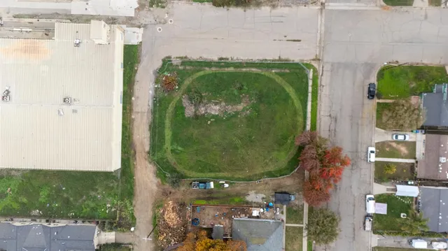 an aerial view of a residential houses with outdoor space and swimming pool