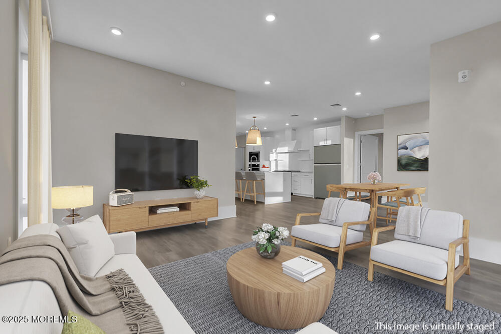 215 2nd Avenue, Unit 108 Asbury Park, NJ 07712 - Photo 5 of 10 a living room with furniture and a flat screen tv