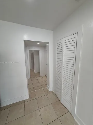 a view of a livingroom with an empty space and a window