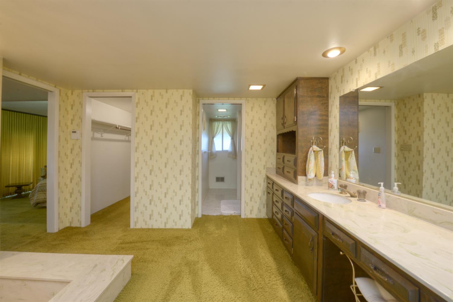 1471 Highway 33 Gustine, CA 95322 - Photo 27 of 57 a bathroom with a granite countertop sink and a mirror
